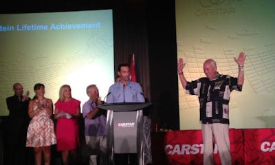 Larry Jefferies (right) accepts the Matthew Orhnstein Lifetime Achievement Award at the 2015 CARSTAR conference.