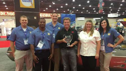 Members of the BASF Automotive Refinish team accepting the top custom car award with Chip Foose. From left to right: Justin Griffin, BASF Sales Development Intern; Marcus Grant, BASF Sales Development Intern; Steve Shemanski, BASF Customer Care Representative; Chip Foose; Tina Nelles, BASF Marketing Services Manager and Kate Kalahar, BASF Customer Care Representative