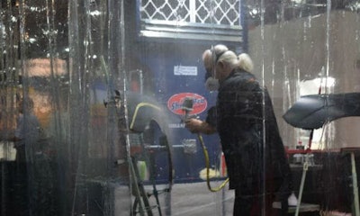 Jon Kosmoski paints at Valspar's NACE booth. The company hosted the legendary painter for numerous demos over the week.