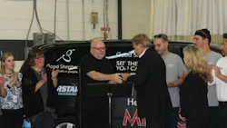 Rick Yates (right) hands over the key to the refurbished van to Brother MacPhee, Executive Director of Good Shepherd.