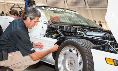 General Motors Global Design Fabrication Operations Director David Bolognino attaches the final panel to complete the restoration the 1-millionth Corvette Thursday, September 3, 2015 at the National Corvette Museum in Bowling Green, Kentucky.