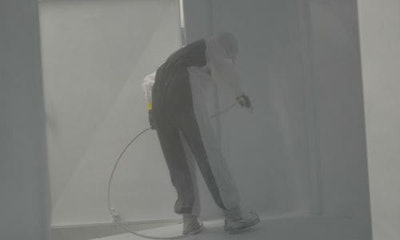 A painter coats the inside of a trailer at Three Star Trucking. The company recently started offering its heavy repair services to other operators.