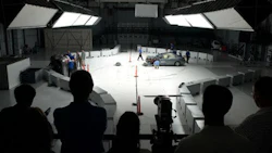 People on the observation deck watch as engineers inspect a car after a crash test at the Vehicle Research Center (VRC). The VRC was the site of today's announcement regarding automatic emergency braking.