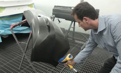 Roger Turmel of Auto Quip uses the Stat Gun to blow off a bumper. Reducing static decreases polishing time.