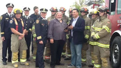 Don Fraser (centre) accepts a plaque honouring his contributions to extrication training for Brampton Fire and Emergency Services.