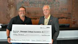 Norm Cross presents the donation to Okanagan College Foundation Development Officer John Haller.