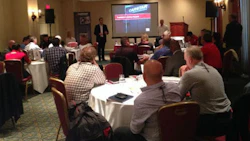 Michael Macaluso, President of CARSTAR Automotive Canada, taking the stage at the CARSTAR multi-store owner performance group meeting.