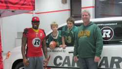 Ottawa REDBLACKS defensive back Javon Johnson was on hand to present the van to Mark Quinn, coach of the East Ottawa Generals (right).