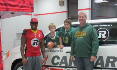 Ottawa REDBLACKS defensive back Javon Johnson was on hand to present the van to Mark Quinn, coach of the East Ottawa Generals (right).