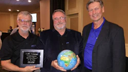 Russell Duncan (centre), Color Compass Corporation's Equipment Specialist, accepting the award from Art Ewing of Pro Spot Canada and Ron Olsson, President of Pro Spot International.