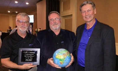 Russell Duncan (centre), Color Compass Corporation's Equipment Specialist, accepting the award from Art Ewing of Pro Spot Canada and Ron Olsson, President of Pro Spot International.