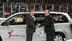 Collin Welsh of CARSTAR hands over the keys to a refurbished van to Robert Howard of the United Way of Durham at an Oshawa Generals game. The van was refurbished thanks to Durham Region CARSTAR stores, Enterprise Rent-A-Car and Discount Car and Truck Rentals.