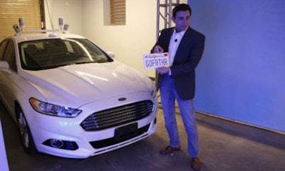 Ford has secured permission to test its autonomous vehicles in California. CEO Mark Fields commemorates the occasion by placing the license plate on an autonomous Fusion Hybrid.
