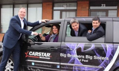 CARSTAR Regional Development Manager Jeff Moriarity and franchise partners Robin Juns and Sam Saccoia present the van to Shari Lynn Ladanchuk, President & CEO of Big Brothers Big Sisters.