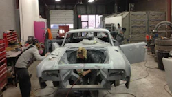 The staff of Ink & Iron, hard at work on the custom '63 Lincoln that will be on display at the Kreator Custom Motorcycles booth.