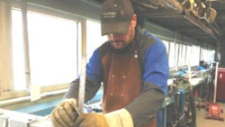 Troy Copeland of CSN-Dana's Collision Center sets up a test weld during his certification.