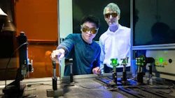 Adrian Sabau and Jian Chen work with a laser to prepare the surface of carbon fibre composites and aluminum to create superior bonds that can absorb 200 percent more energy than conventional bonds.