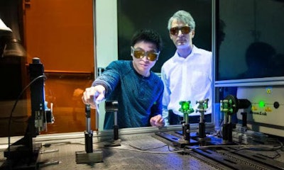 Adrian Sabau and Jian Chen work with a laser to prepare the surface of carbon fibre composites and aluminum to create superior bonds that can absorb 200 percent more energy than conventional bonds.