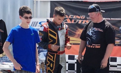Nathan Goncalves (left) presents this year’s donation cheque to Austin Riley and his father, Jason Riley.
