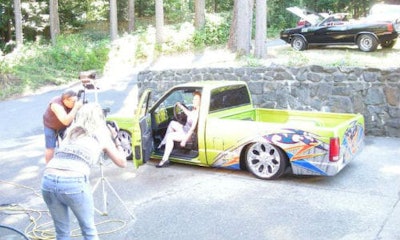A model poses for a calendar shoot with a mini truck Wes Mclean worked on. McLean was a rising star in mini truck when he was involved in a collision in 2012.