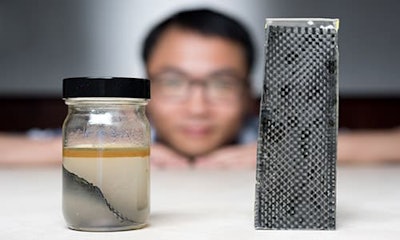 A research team at Georgia Tech has developed a new way of recycling carbon. Pictured above, one of the men involved in the project Kai Yu shows off the team's method – immersing carbon fibre composites in alcohol.