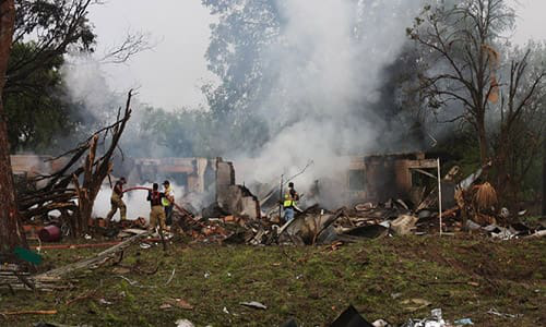 A truckload of airbag detonation triggers explode while in transit along the Texas border, injuring several people within the vicinity and completely destroying both the truck carrying the devices and a nearby home.