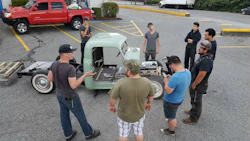 CUT Program participants and volunteers discuss a current build, a '47 Chevy pickup. The program, which provides at-risk youth with practical experience, needs a new space in which to continue its work.