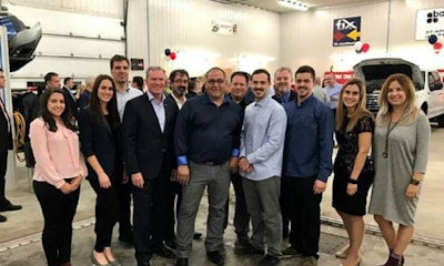 Stéphane Plante and his two sons at the Grand Opening event, accompanied by Fix Auto headquarters employees.