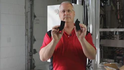 Carl Dumele, CEO of Aeromotive holds up two parts for a visual inspection. The part on the left is the original, damaged bracket. The one on your right is a new part Aeromotive turned out with its 3D printer.