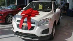 It's a car bow for a new generation! The Car Bow Store is the company behind a lot of the big bows you see in dealerships. They've switched to suction cup attachments instead of magnets to allow the bows to be attached to aluminum hoods.