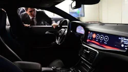 Prime Minister Justin Trudeau examines a vehicle at the Blackberry QNX facility.