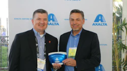 Mike Carr, Axalta's President - North America and Michael Gogoel, President of BYK-Gardner USA with a commemorative spectrophotometer painted with Brilliant Blue, Axalta’s North American Automotive Color of the Year 2016.