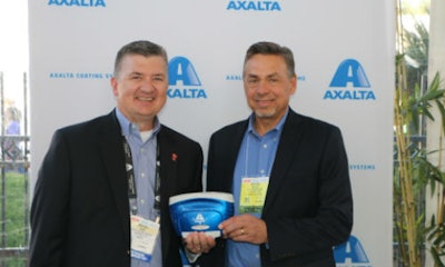 Mike Carr, Axalta's President – North America and Michael Gogoel, President of BYK-Gardner USA with a commemorative spectrophotometer painted with Brilliant Blue, Axalta’s North American Automotive Color of the Year 2016.