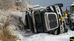 An upturned truck lies in a ditch after a massive crash along the 401. More than 100 vehicles were involved in the incident.