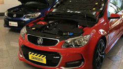 Geniune Holden hood on the left, counterfeit on the right. Aside from the sheer illegality, the main concern is that the counterfeit hoods are made from steel rather than aluminum. The vehicles in question were not designed with steel hoods in mind, and the associated parts can't handle the weight.