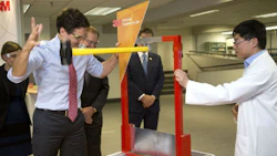 Prime Minister Justin Trudeau at 3M’s Canadian headquarters, swinging a hammer at a new super-strong tape being developed as an alternative to rivets and fasteners.