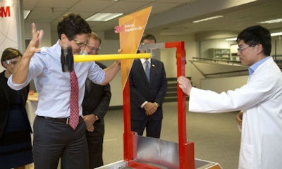Prime Minister Justin Trudeau at 3M’s Canadian headquarters, swinging a hammer at a new super-strong tape being developed as an alternative to rivets and fasteners.