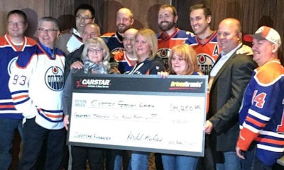 CARSTAR franchise partners, staff and members of the Edmonton Oilers Communication Foundation present the donation to Cystic Fibrosis Canada.