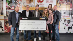 Presenting the donation to Cystic Fibrosis Canada. From left: Scott Lavery of CARSTAR, Michael Piper of CARSTAR, T.J. Brodie of the Calgary Flames, Candace Goldie of the Calgary Flames Foundation and Brand Newell of Cystic Fibrosis Canada and his family.
