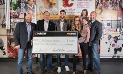 Presenting the donation to Cystic Fibrosis Canada. From left: Scott Lavery of CARSTAR, Michael Piper of CARSTAR, T.J. Brodie of the Calgary Flames, Candace Goldie of the Calgary Flames Foundation and Brand Newell of Cystic Fibrosis Canada and his family.