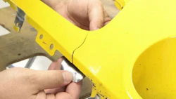 A technician begins a repair on a Dodge Challenger bumper. A new video from Polyvance notes that repairing pieces with certain colours, instead of replacing them, can save frustration in the paint department.