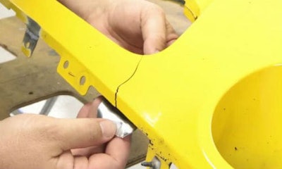 A technician begins a repair on a Dodge Challenger bumper. A new video from Polyvance notes that repairing pieces with certain colours, instead of replacing them, can save frustration in the paint department.