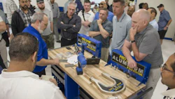 A Pro Spot staff member demonstrates the Pro Spot PR-5 Rivet Gun system, special dies and extension arms for the management team from Craftsman Collision.