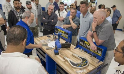A Pro Spot staff member demonstrates the Pro Spot PR-5 Rivet Gun system, special dies and extension arms for the management team from Craftsman Collision.