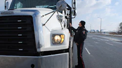 Pictured: Constable Phil Steward inspecting a tow truck in Whitby. Durham Police officers laid 59 charges in total over the two-day safety blitz, for infractions such as inoperative braking systems and load security.