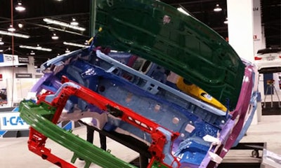 Various metals, including aluminum (green), magnesium (yellow), and press-hardened ultra-high-strength steel (maroon) can be seen on the 2017 Chrysler Pacifica at NACE 2016. Also visible is the composite front structure (red). (Photo by John Huetter/Repairer Driven News)