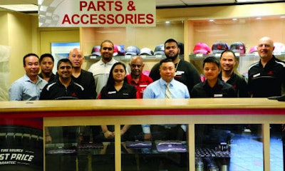 Cuong Phung (centre, shirt and tie) and team of parts specialists at Formula Honda.