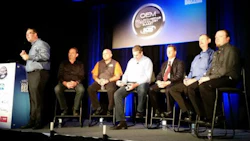 SCRS Executive Director Aaron Schulenburg (left) introduces an aftermarket scan tool panel at the OEM Collision Repair Technology Summit at SEMA in 2016. Photo by John Huetter of Repairer Driven News.