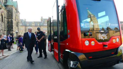 Transport Minister Marc Garneau prepares to board an automated bus built by TransDev during a demonstration on Parliament Hill on Wednesday.