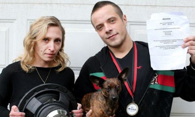 Dustin Hamilton with his girlfriend, Katrina Jourdenais, and their dog, Luna. Hamilton is a professional car audio installer, but it turns out his neighbours think he's too good at his job. The sheet of paper he's holding was put up in his neighbourhood, asking residents to complain to police about his car stereo.
